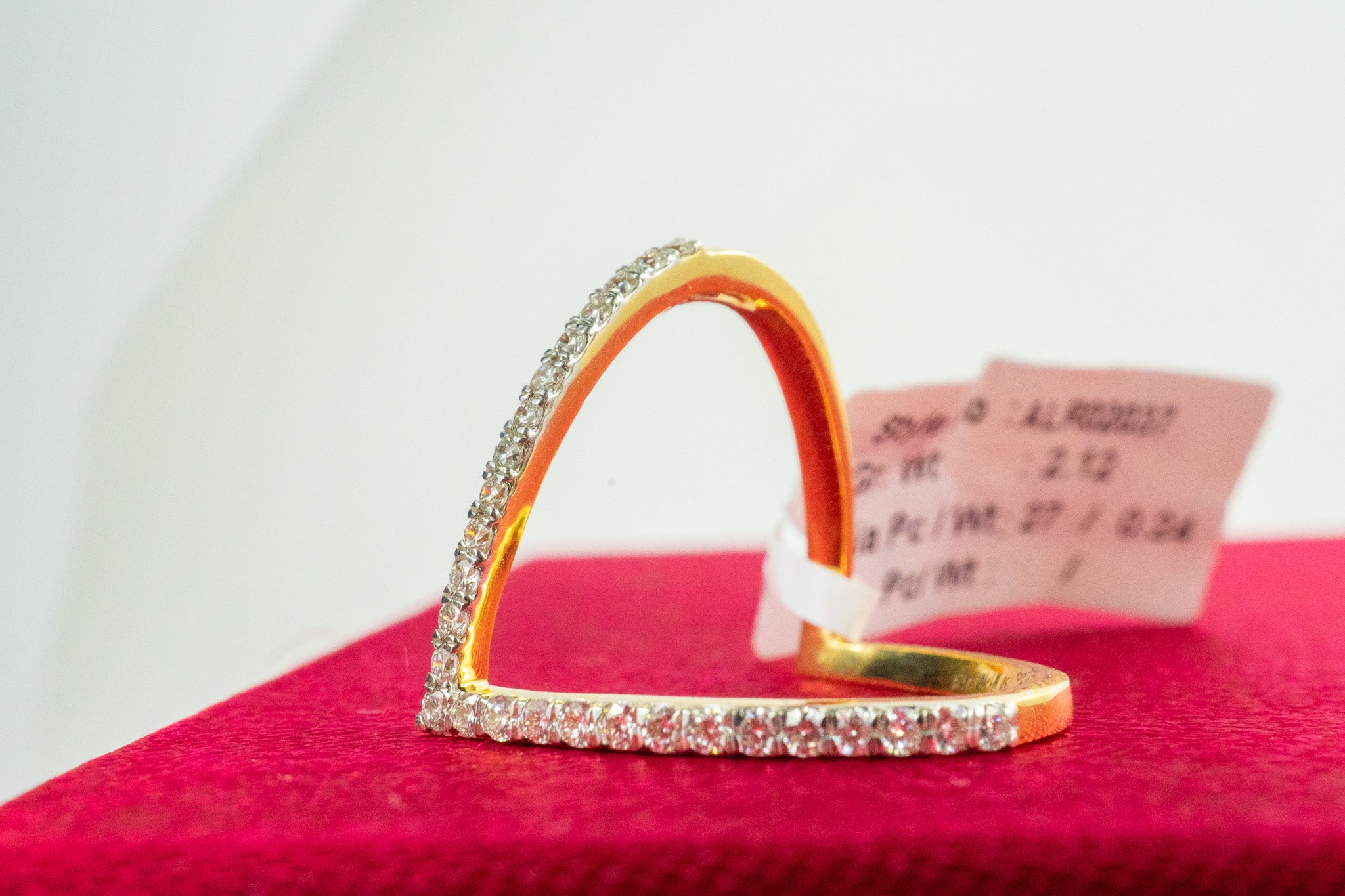 18K gold open heart pavé diamond ring photographed on a dark background