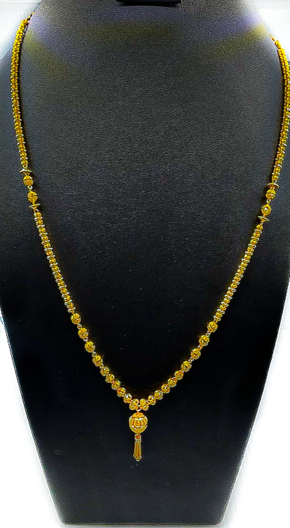 22K gold long necklace 38.27 g displayed on a black velvet bust