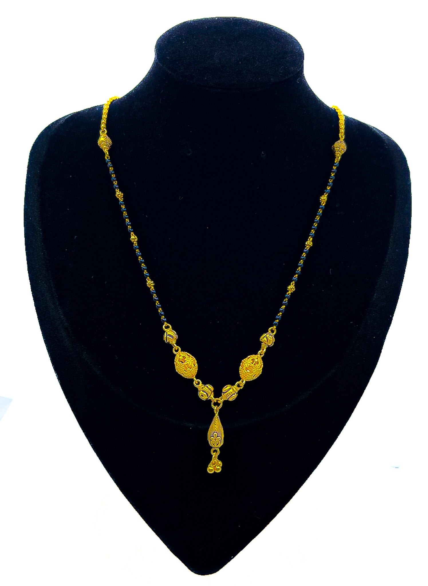 22K gold mangalsutra necklace 11.01 g with black beads and gold pendant drop on black velvet bust