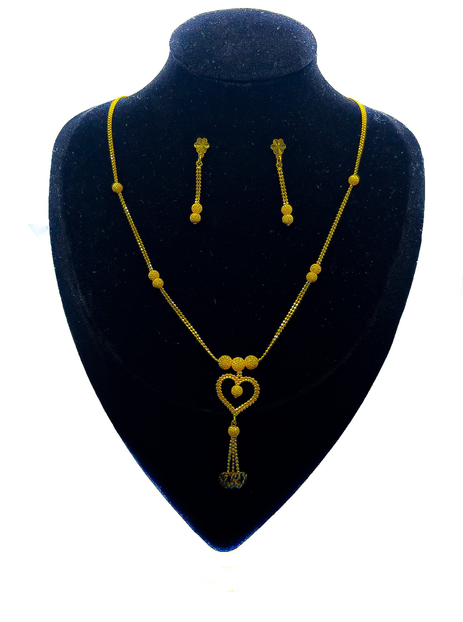 22K gold heart necklace and matching drop earrings set displayed on black velvet bust