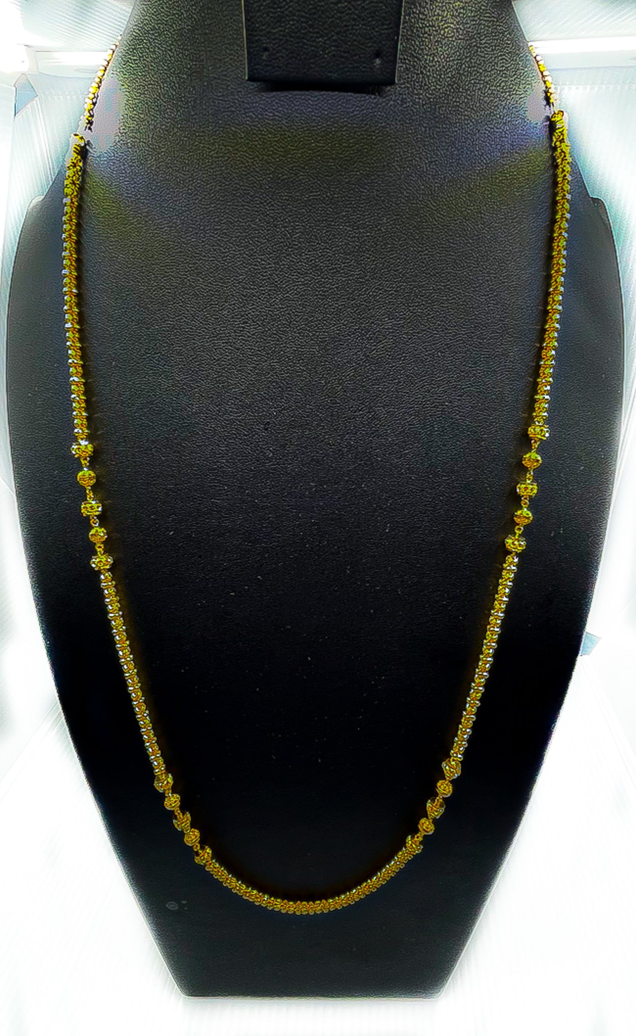 22K gold long necklace 35.13 g displayed on a black velvet bust
