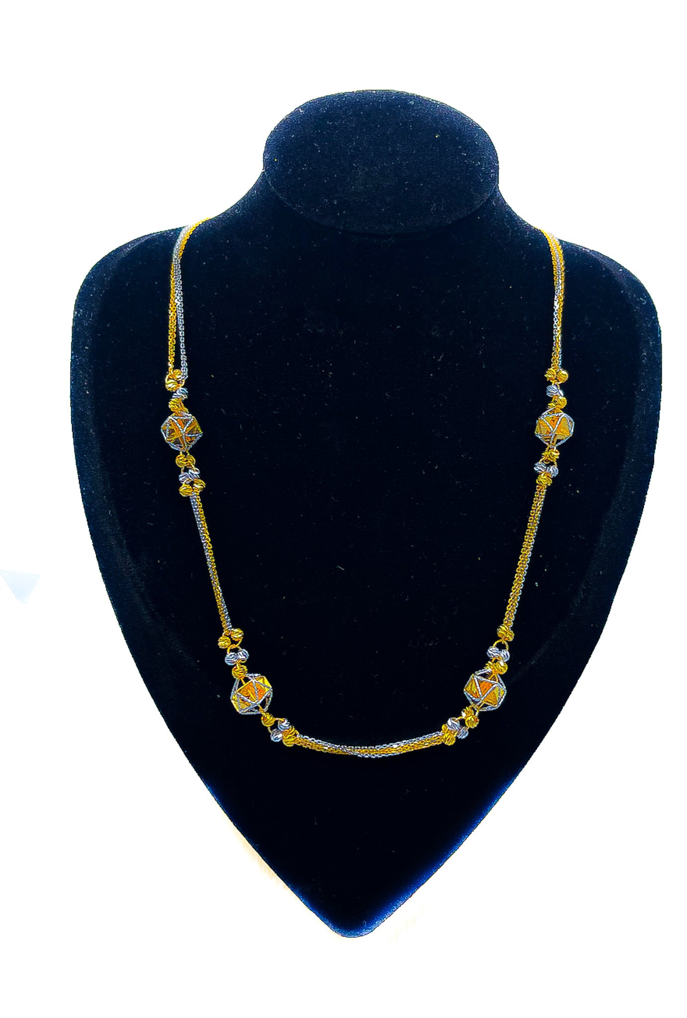 22k yellow gold station chain necklace with blue accent details displayed on black velvet mannequin bust