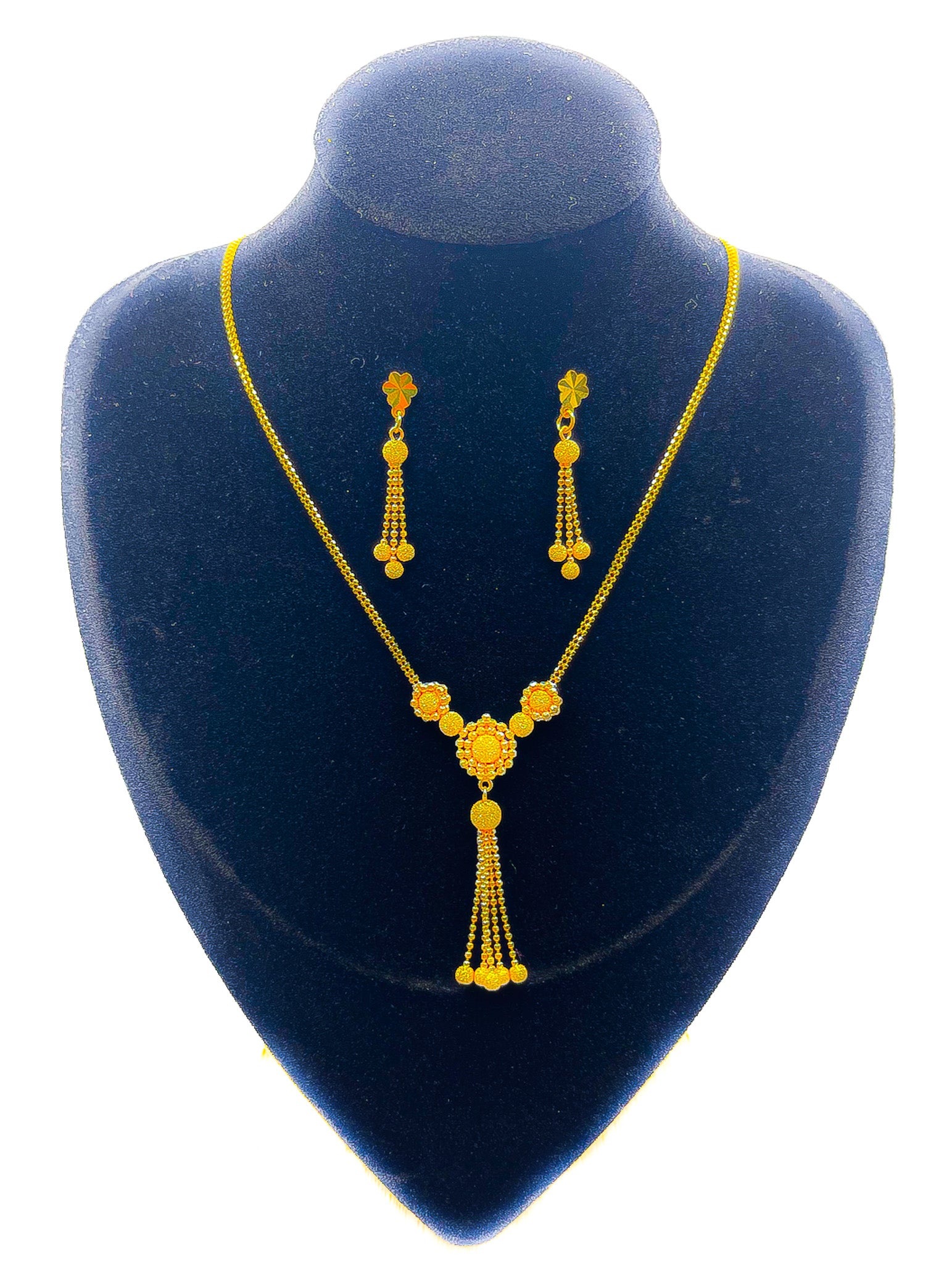 22K gold necklace and matching dangle earrings set on black velvet display, 12.24g