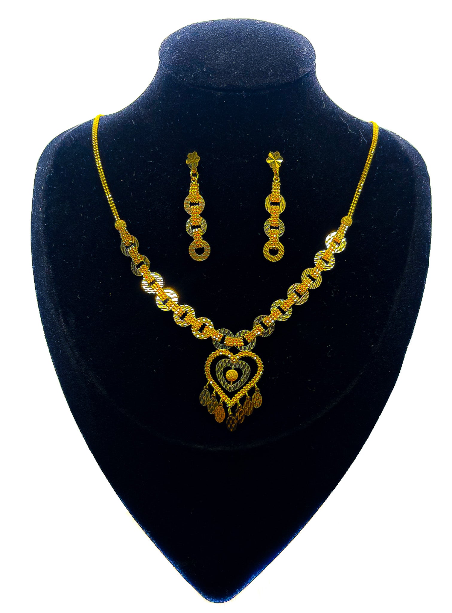 22K gold necklace and matching earrings set with heart pendant on black velvet mannequin, white background