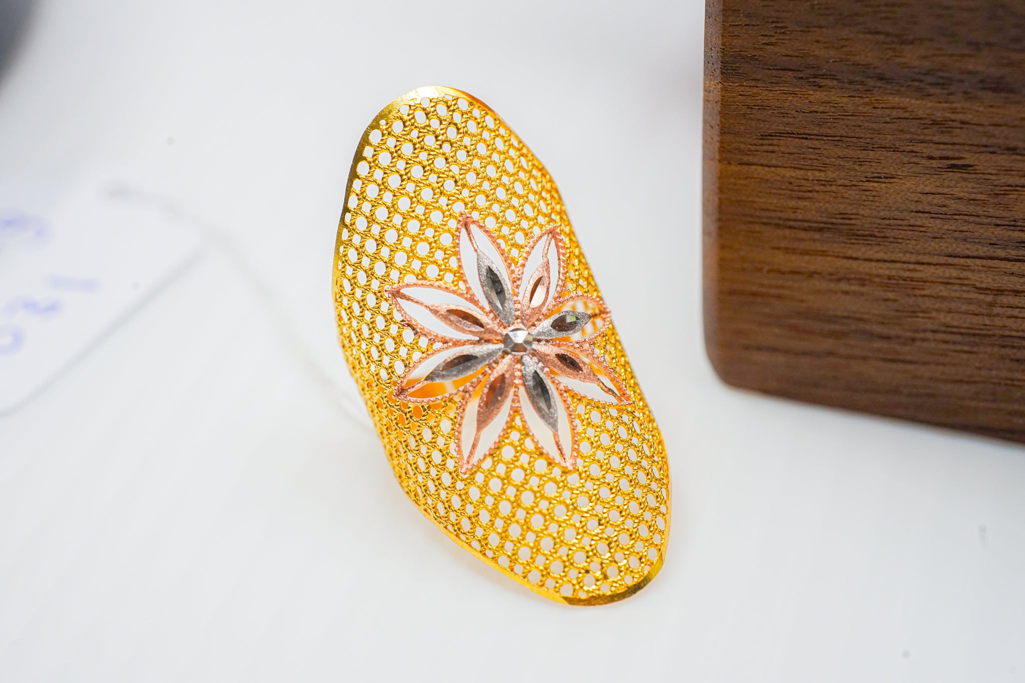 22k gold statement ring with openwork mesh design and floral center motif with rose and white toned accents