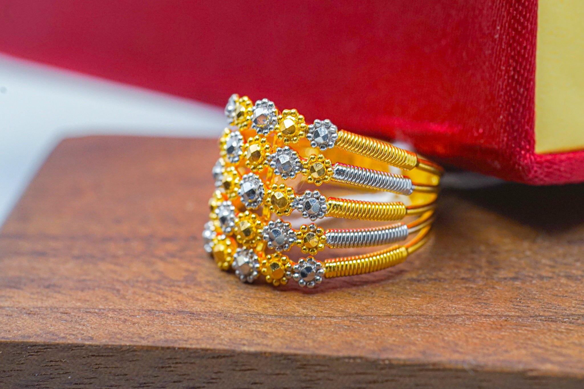 22k gold wide band ring with floral design and silver-tone accents.