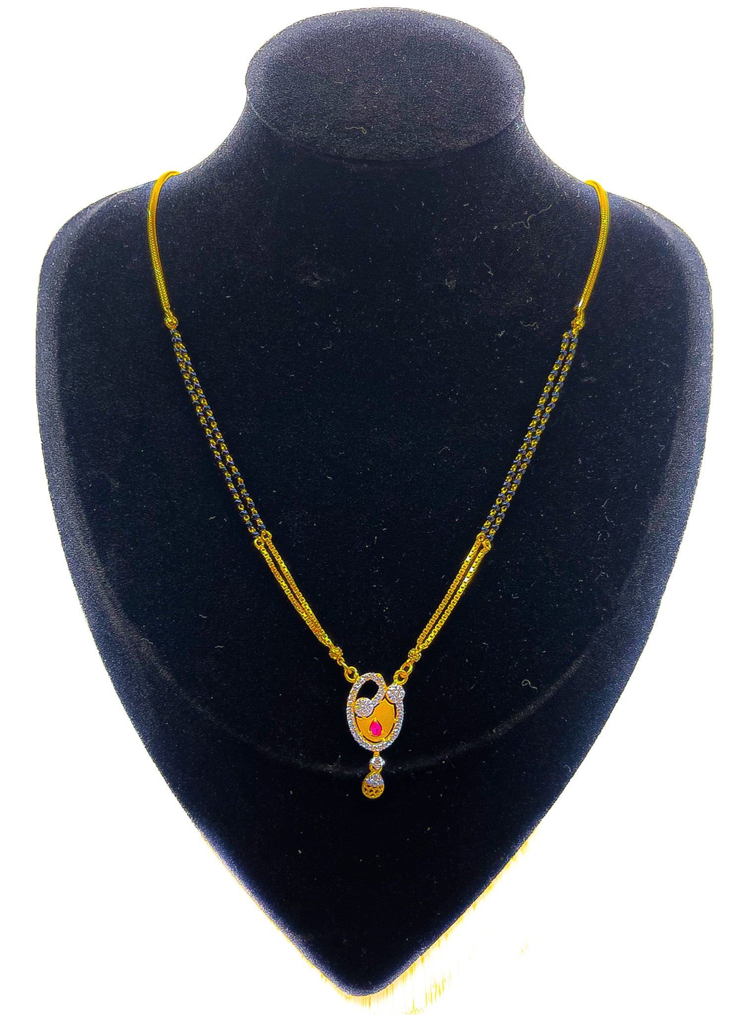 22k yellow gold mangalsutra necklace with pendant and blue bead accents displayed on black mannequin bust