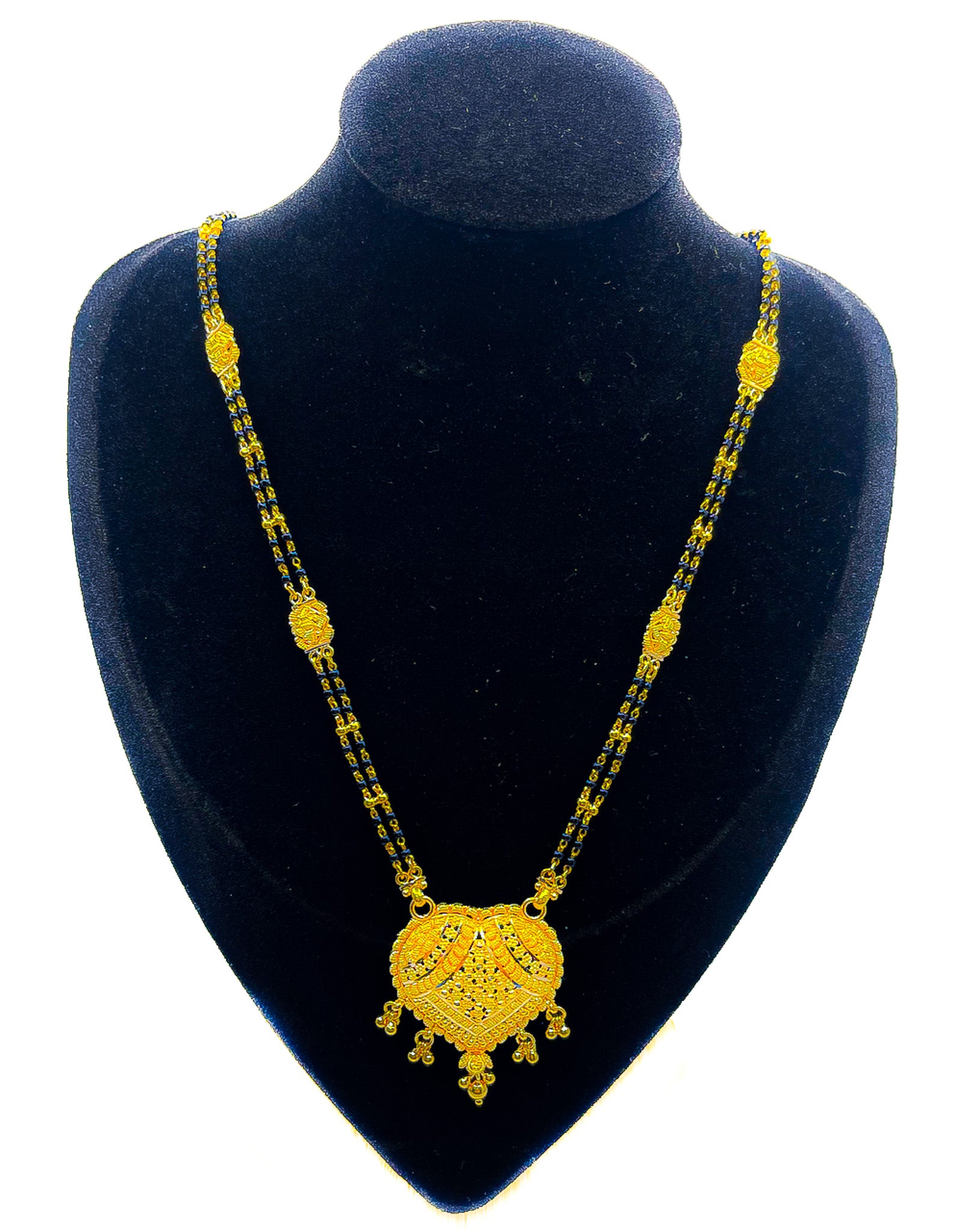 22k yellow gold necklace with black beaded chain and heart-shaped pendant displayed on black velvet mannequin bust