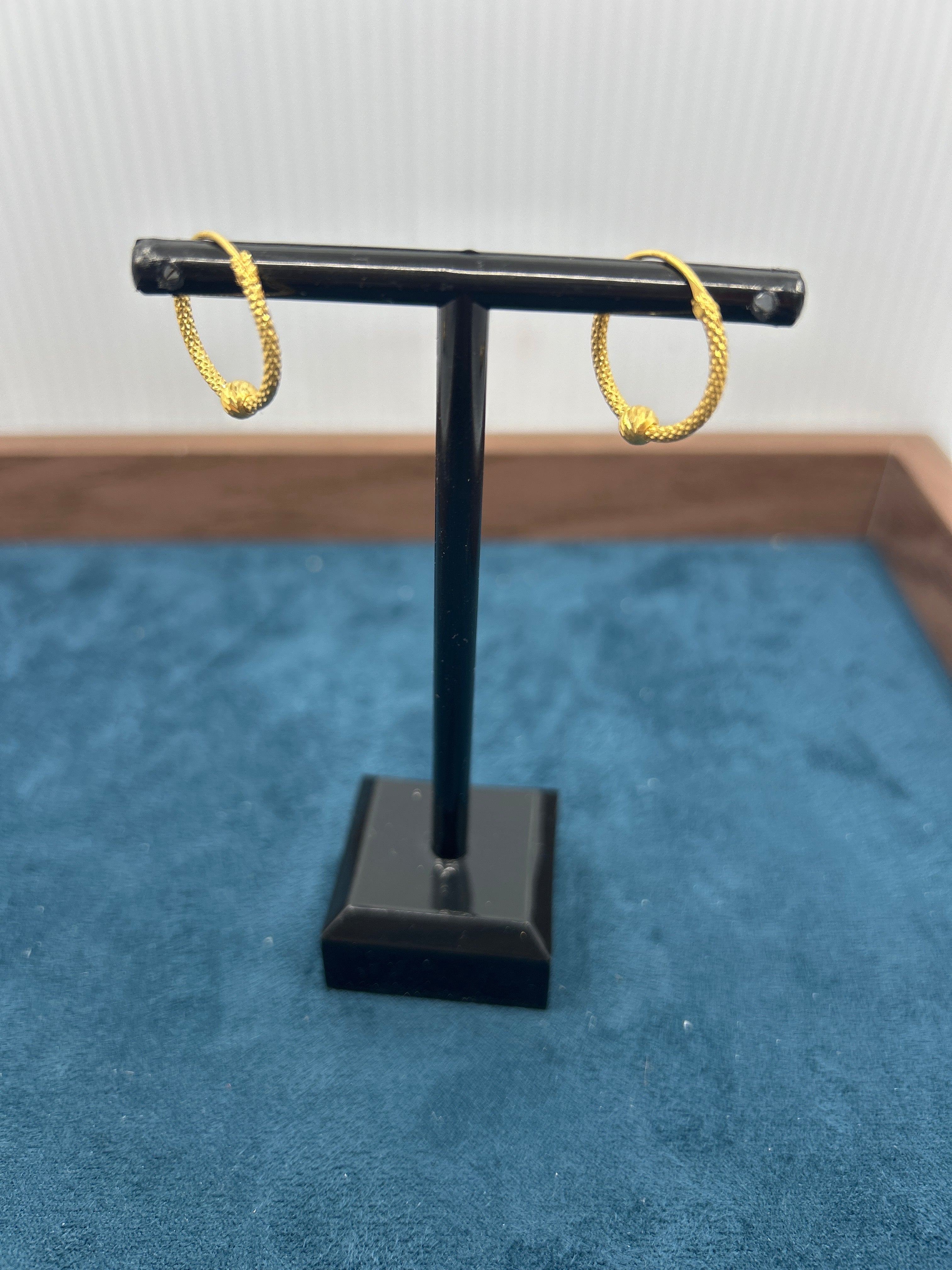 Black door handle with gold accents on a blue textured door
