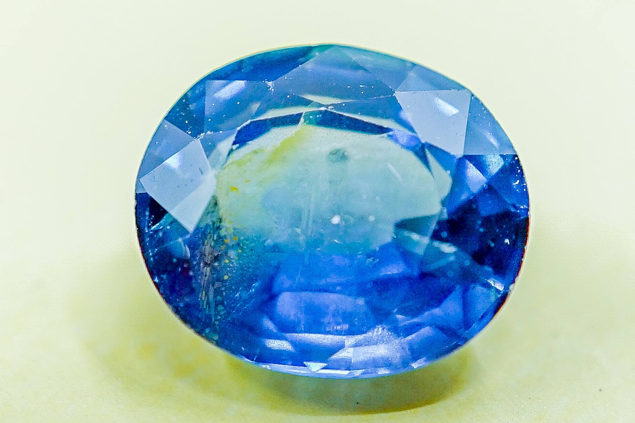 Close-up of an oval faceted blue sapphire loose gemstone