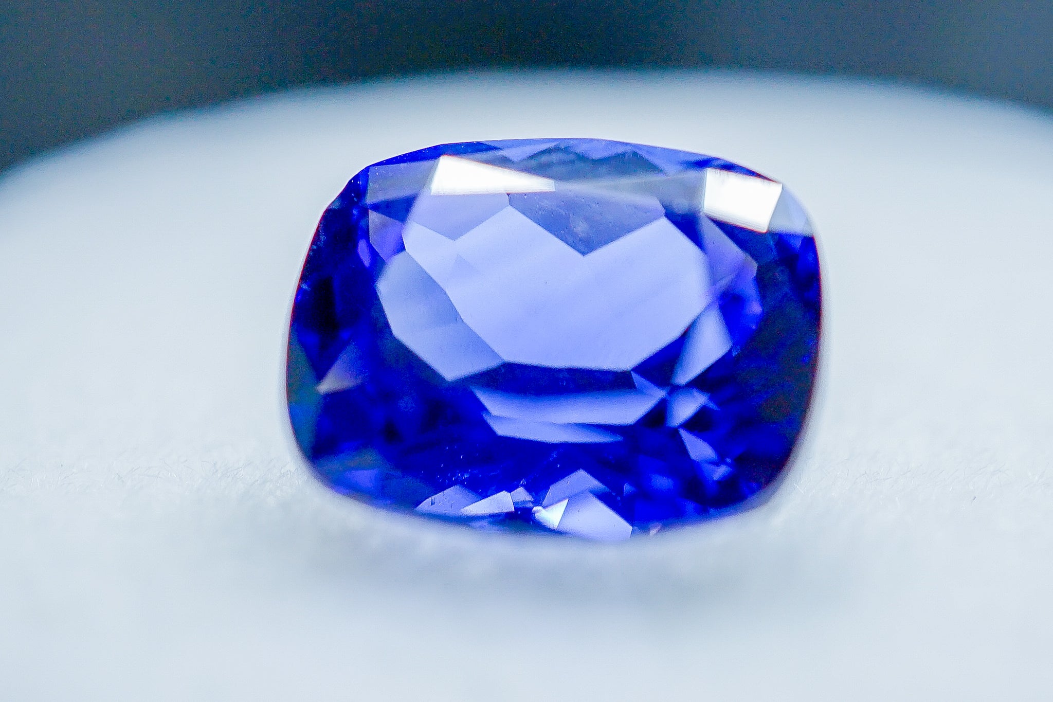 Close-up of faceted oval blue sapphire loose stone
