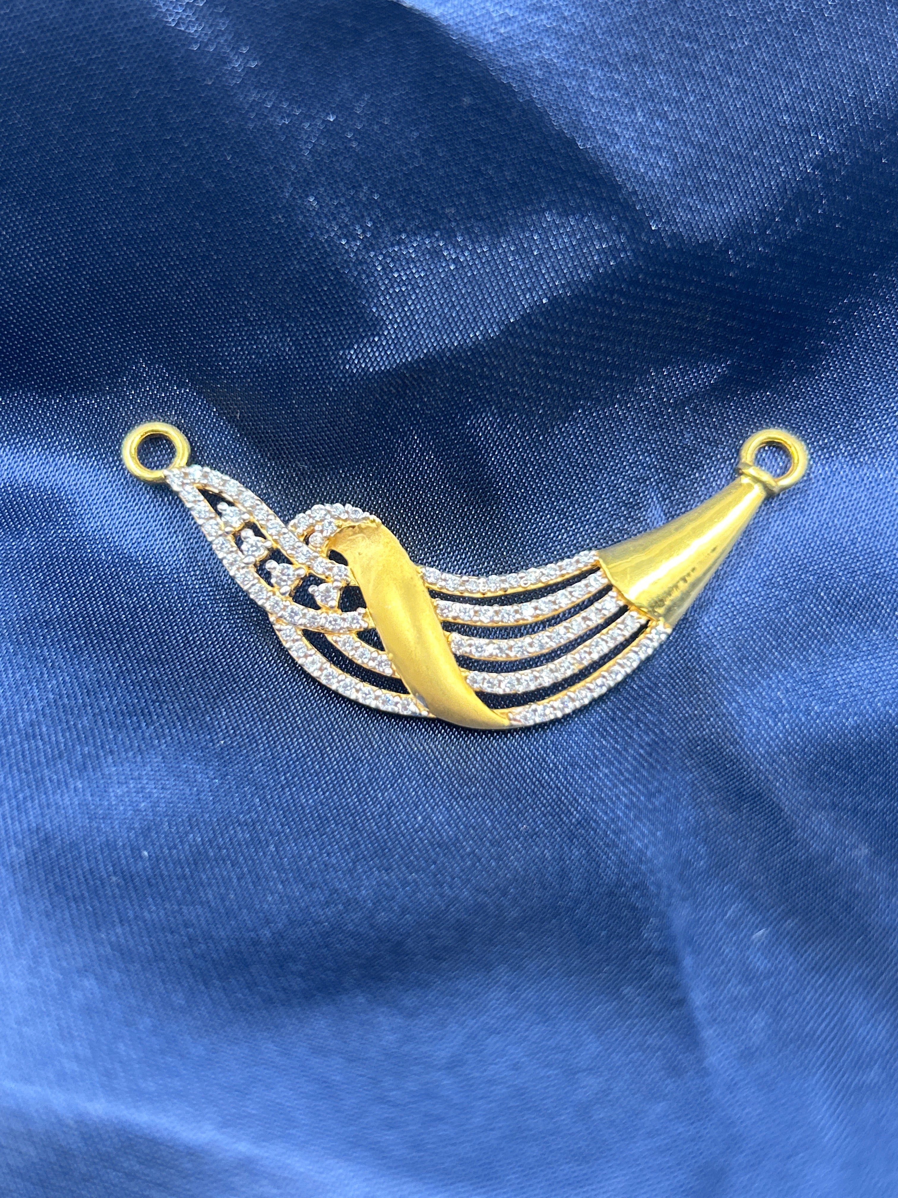 Decorative yellow and silver tassel on a blue fabric background