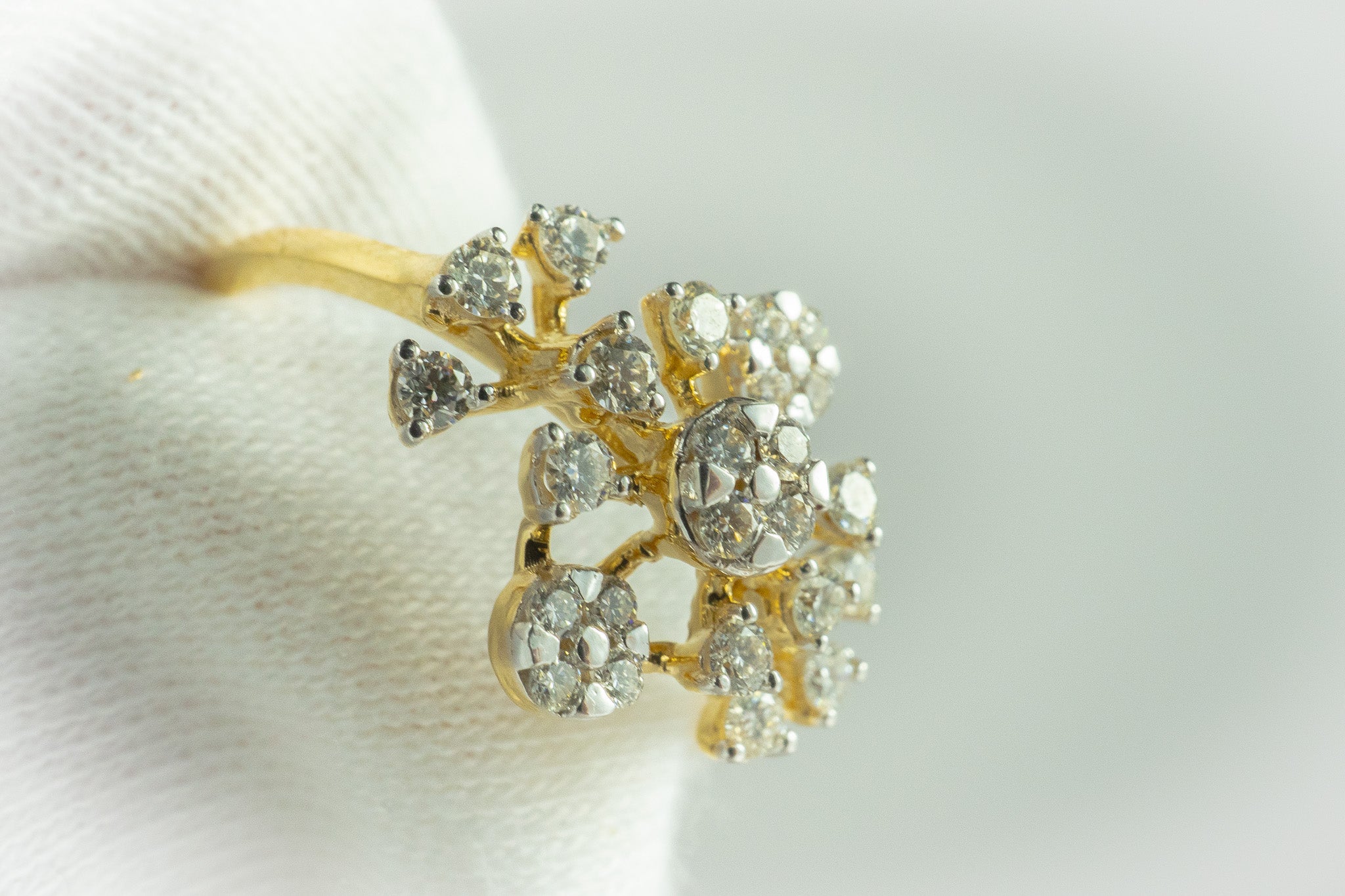 Gold floral cluster diamond ring with 0.32 carat total diamond weight, close-up view