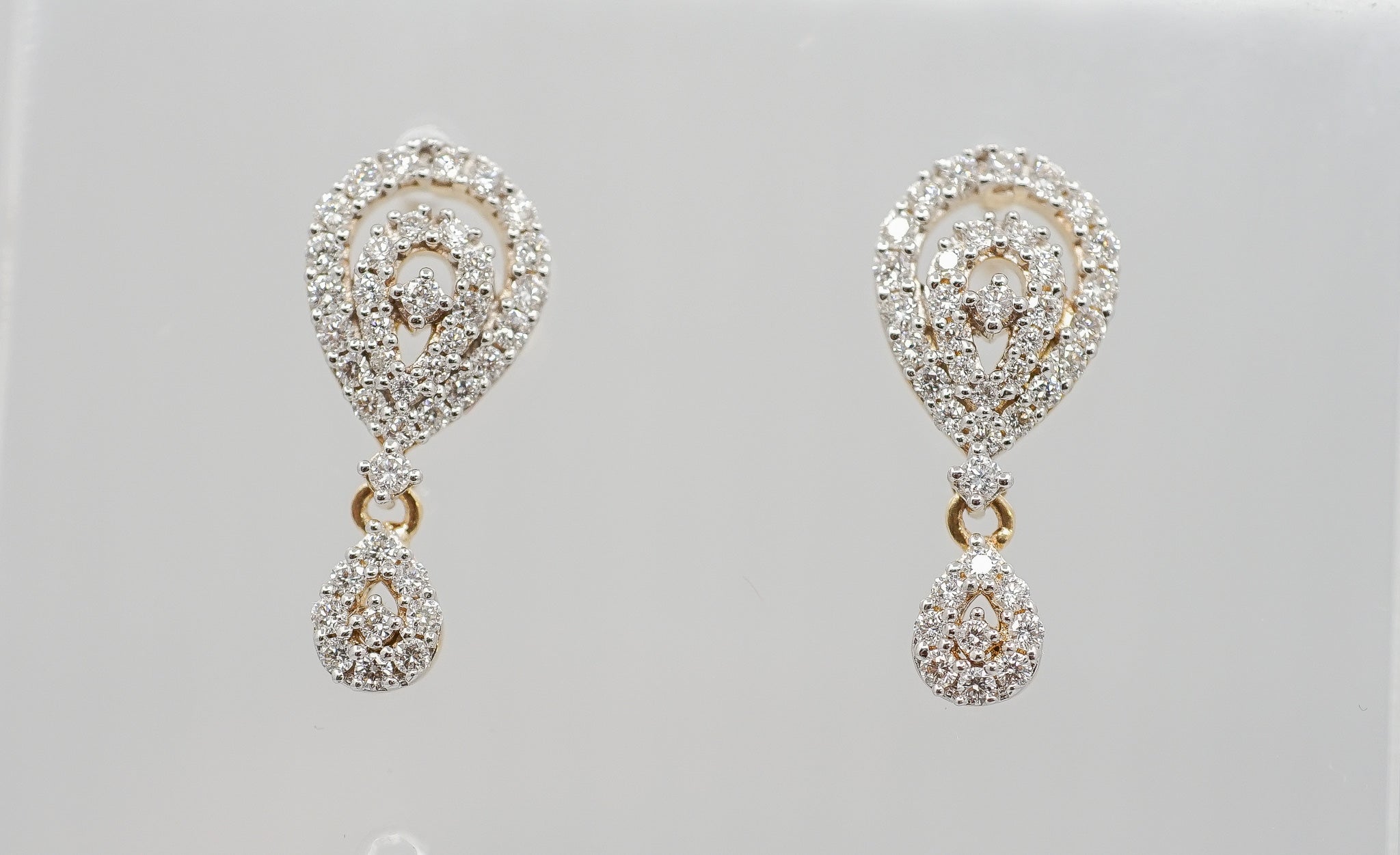 Pair of Chic Charm teardrop diamond drop earrings with pear-shaped swirl tops and dangling teardrop charms.