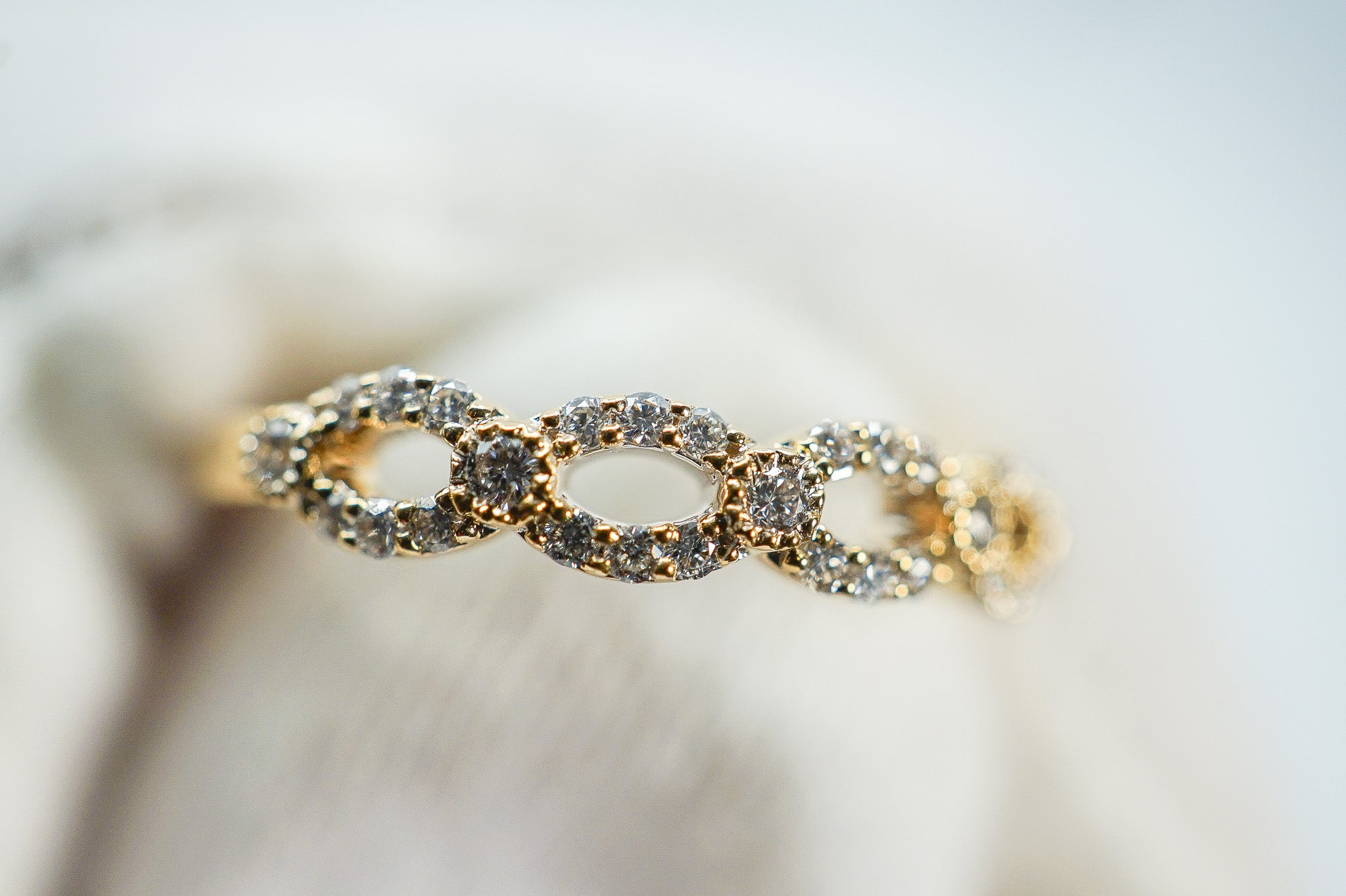 side view of an 18k gold diamond oval link band ring showing the open-oval link design (0.22 carat total diamond weight)